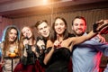 Trendy young singers in karaoke bar