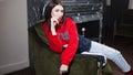 Trendy young woman ia a red hoodies. Portrait in fashionable interior.