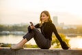 Trendy young woman listening music from smartphone outdoor at sunset Royalty Free Stock Photo