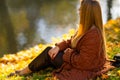 Trendy young woman relaxing outdoors at a park. Royalty Free Stock Photo