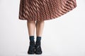 Trendy young woman`s legs with aery flitting skirt. Royalty Free Stock Photo