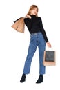 Trendy youth girl standing with shopping bags in studio Royalty Free Stock Photo