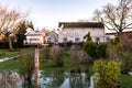 Doves flying into nesting box in the beer green of the rural idyllic River Trent side public house and restaurant during evening