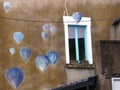 Trentemoult, colorful houses of the former fishing village. Facade decorated with hot air balloons under the storm Royalty Free Stock Photo