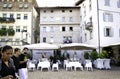 House where the author Giambattista Garzetti lived, seen from Piazza Duomo, Trento, Italy. The terrace of a restaurant and people