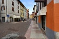 One of the beautiful streets of the historic center of Trento characterized by brightly colored facades.