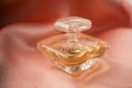 Tresor de Lancome bottle of perfume on satin background