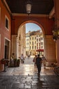 Arcades in Piazza dei signori in Treviso with people passing through