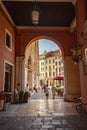 Arcades in Piazza dei signori in Treviso with people passing through 2