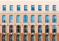 Tri-color facade with high windows. Architectural details