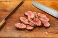 rare grade tri-tip steak sliced on cutting board Royalty Free Stock Photo