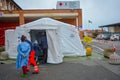 A triage tent in front of a hospital. Nurses and doctors go in and out of emergency site in time of covid-19 pandemic