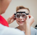 Trial frame. Glasses for a little boy. Ametropia correction with glasses.