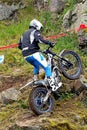 Trial motorcycle rider on rocky slope with wheel spin Royalty Free Stock Photo
