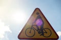 Triangle bicycle sign transit prohibited for bicycles on blurred park background. Bicyle road sign, prohibition yellow Royalty Free Stock Photo