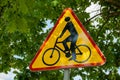 Triangle bicycle sign transit prohibited for bicycles on blurred park background. Bicyle road sign, prohibition yellow Royalty Free Stock Photo