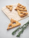 Triangle cookies with rosemary. Vertical. High view.