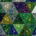 Triangle dark background in violet, green, blue,yellow and black colors with effect of stained glass Royalty Free Stock Photo