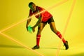 Triangle neon over african american young rugby player playing against yellow background