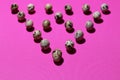 A triangle of quail eggs on a textured pink background Royalty Free Stock Photo