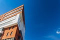 Triangle red and white building foreshortening from below modern architecture shape office urban landmark view with vivid blue sky Royalty Free Stock Photo