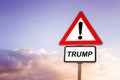 Triangle road sign with the word Trump