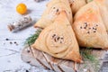 Triangle samsa meat pastry with sesame seeds on wooden board Royalty Free Stock Photo