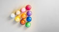 Triangle shape of coffee capsules of different colors on a gray background top view