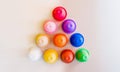 Triangle shape of coffee capsules of different colors on a gray background top view