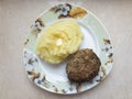 Triangle shape plate with potato mash and homemade cutlet