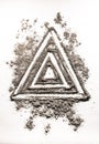 Triangle shape symbol drawing in dust as order in chaos