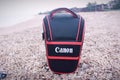 A triangular Canon camera bag for the camera body and one lens.