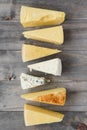 Triangular cheese chunk arranged row wooden plank. High quality and resolution beautiful photo concept