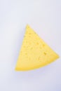 Triangular Chunk Wedge of Alpine Creamy Appetizing Light Yellow Tilsit Cheese on White Background. Texture with Cracks and Holes Royalty Free Stock Photo