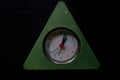 A triangular clock on black background.