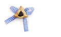 Triangular cookies with poppy seeds hamantasch or aman ears with blue ribbon on white background with space for text