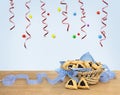 Triangular cookies with poppy seeds hamantasch or aman ears and blue ribbon on wooden table on blue background