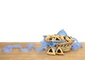 Triangular cookies with poppy seeds hamantasch or aman ears and blue ribbon on wooden table on white background