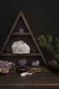 Triangular Crystal Shelf on a Wooden Surface with Jewellery and Foliage