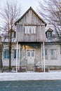 Triangular gazebo on stilts stands above the entrance to the house in the courtyard