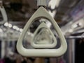 Triangular hanging railings in a subway car