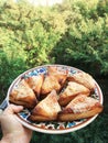 triangular Israeli bureks with cheese on a plate.