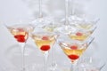 Triangular martini glasses, filled with champagne with cherries built in the shape of a pyramid, top view Royalty Free Stock Photo