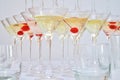 Triangular martini glasses, filled with champagne with cherries and liquid nitrogen, creating steam, shape of a pyramid