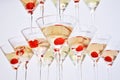 Triangular martini glasses, filled with champagne with cherries in the shape of a pyramid, bottom view Royalty Free Stock Photo