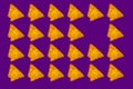 Triangular nachos on purple color background