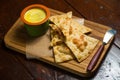 Triangular pieces of tortilla with pÃÂ¢tÃÂ© and sauce