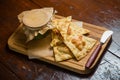 Triangular pieces of tortilla with pÃÂ¢tÃÂ© and sauce