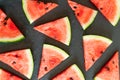 Triangular pieces of water melon spread on black Royalty Free Stock Photo