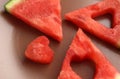 Triangular pieces of watermelon with heart cut from watermelon pulp in a brown cup, red watermelon Royalty Free Stock Photo